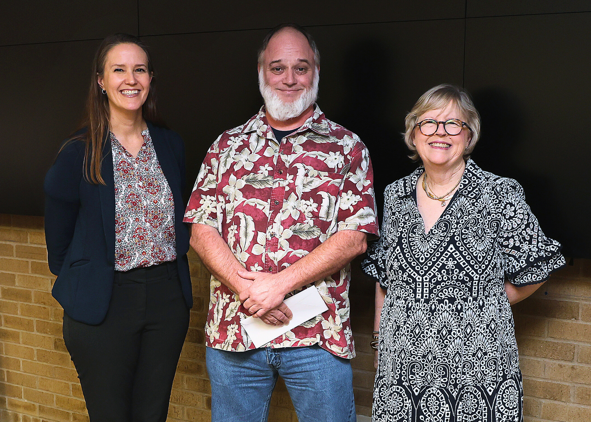 Longevity service award winner standing between the University Librarian and a representative from the Friends of the Texas A&M University Libraries